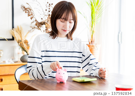 貯金をする女性 貯金をする女性 137592834