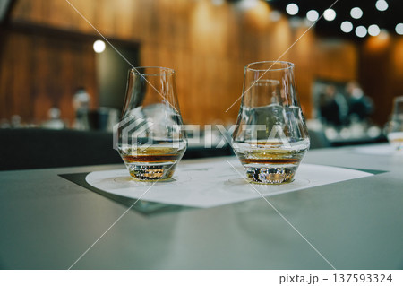 Glasses of whiskey on a table in a tasting event Glasses of whiskey on a table in a tasting event 137593324