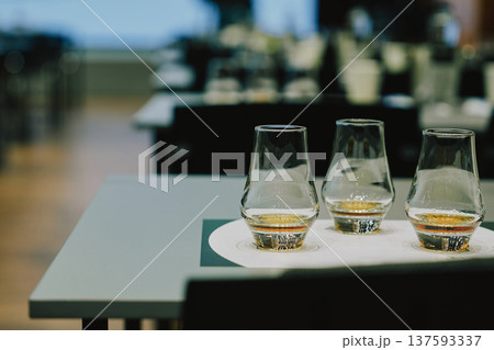 Glasses of whiskey on a table in a bar setting Glasses of whiskey on a table in a bar setting 137593337
