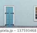Blue wooden door on clean wall 137593468