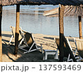 Deck chairs under straw umbrellas 137593469