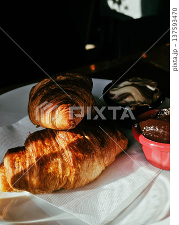 Fresh croissants served with chocolate Fresh croissants served with chocolate 137593470