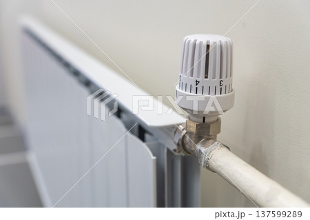Close-up of a white thermostatic radiator valve Close-up of a white thermostatic radiator valve 137599289
