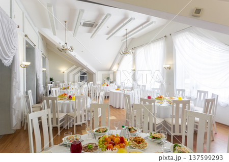 Bright restaurant dining room prepared for a banquet. 137599293