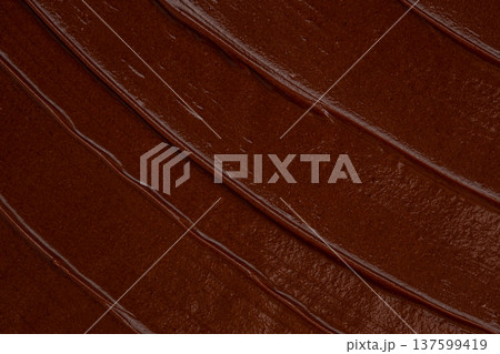 Smooth chocolate spread texture with glossy cocoa cream background Smooth chocolate spread texture with glossy cocoa cream background 137599419