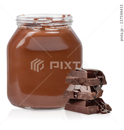 Chocolate spread jar with stacked dark chocolate pieces isolated on white Chocolate spread jar with stacked dark chocolate pieces isolated on white 137599433