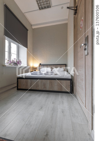 Compact Minimalist Hotel Room with Double Bed and Window Compact Minimalist Hotel Room with Double Bed and Window 137600506