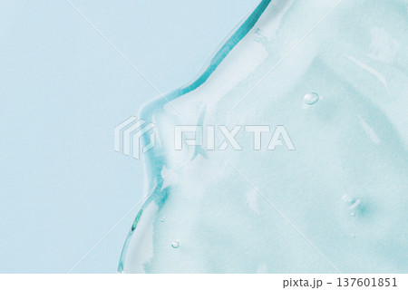 Transparent hyaluronic acid gel on a blue background. 137601851