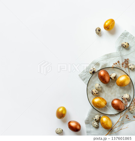 Golden and bronze Easter eggs in a grey plate 137601865