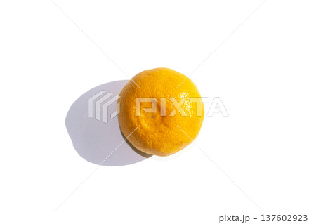 It is a tangerine lying on a white background. 137602923