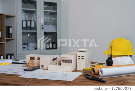 Construction house and building. workspace area. dof laptop computer and office construction on table in office blurred background, Architect concept. 137603072