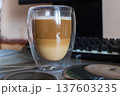 Layered Latte Macchiato in Double Walled Glass on Desk with Mechanical Keyboard 137603235