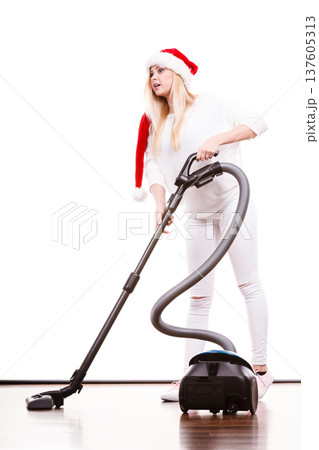 Girl in santa helper hat with vacuum cleaner Girl in santa helper hat with vacuum cleaner 137605313