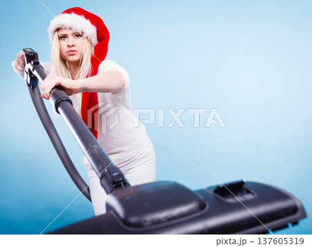 girl in santa helper hat with vacuum cleaner 137605319