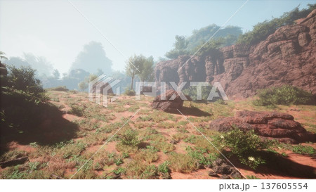 Sunlight filters through the mist, illuminating a striking landscape of rocky cliffs and vibrant greenery. The scene captures the tranquil beauty of nature, alive with colors and textures. 137605554