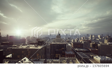 sunrise over historic city skyline, soft golden light spills across rooftops and distant dome, wet streets reflect muted clouds, aerial perspective suggests 137605694