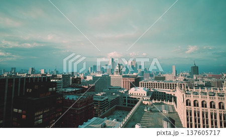 rooftop city skyline dawn pastel light, historic brick buildings stretching toward distant metropolis, soft clouds and cinematic drone glide, warm tones rooftop city skyline dawn pastel light, historic brick buildings stretching toward distant metropolis, soft clouds and cinematic drone glide, warm tones 137605717