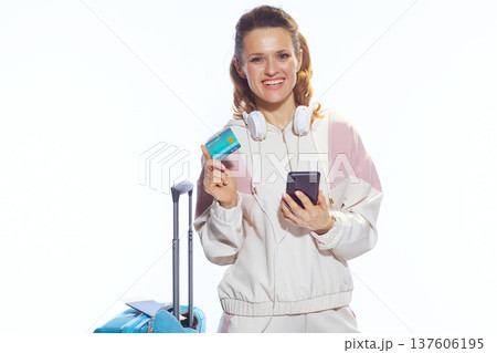 Cheerful Woman Managing Travel Plans with Phone and Card Cheerful Woman Managing Travel Plans with Phone and Card 137606195