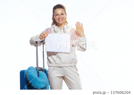 Friendly Female Traveler Holding Empty Sign and Waving 137606204