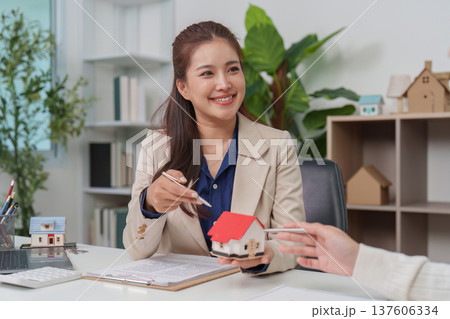 Real Estate Consultation. Professional agent discussing property details with client. Real Estate Consultation. Professional agent discussing property details with client. 137606334