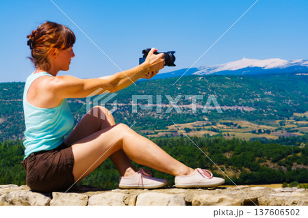 Woman take photo on mountain nature in France Woman take photo on mountain nature in France 137606502
