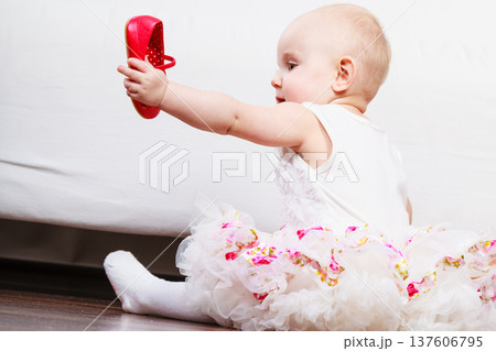 Little girl with red shoes Little girl with red shoes 137606795