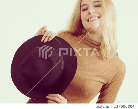 Woman wearing suede and black hat 137606804