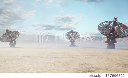 desert observatory arrays under morning sky, massive rusted metal dishes rise from sandy plain, low mist drifts across horizon, dishes slowly rotate scanning desert observatory arrays under morning sky, massive rusted metal dishes rise from sandy plain, low mist drifts across horizon, dishes slowly rotate scanning 137606822