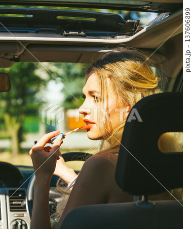 Girl apply make up while driving car. Girl apply make up while driving car. 137606899