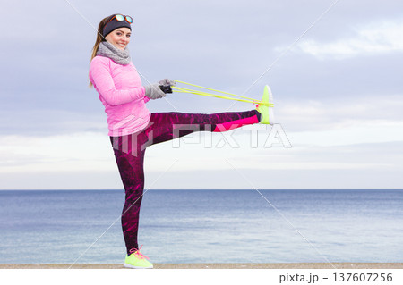 Woman training outdoor with jump rope on cold day Woman training outdoor with jump rope on cold day 137607256