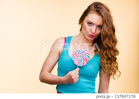 Woman joyful girl with lollipop candy 137607276