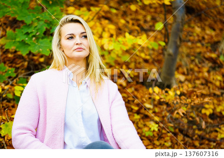 Sad woman in autumn park 137607316
