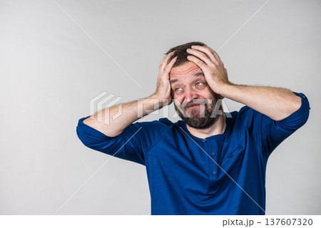 Worried man gesturing with hands 137607320