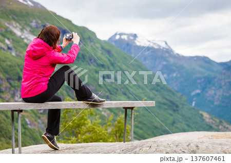Tourist with camera looking at scenic view in mountains Norway 137607461