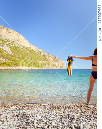 Woman with flippers snorkeling tube on beach Woman with flippers snorkeling tube on beach 137607463