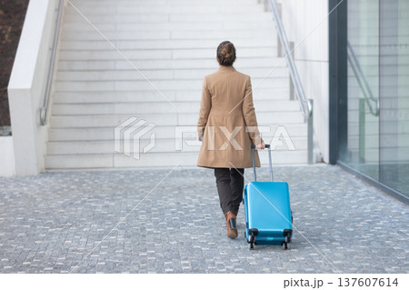 Solo Female Traveler Navigating Modern Railway Station 137607614