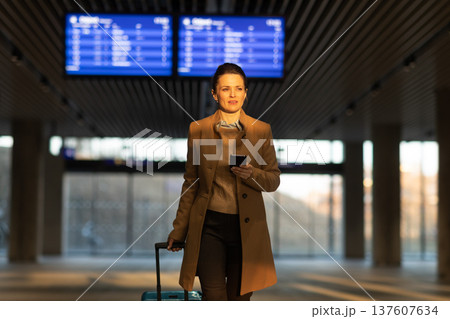 Confident Female Traveler at Train Station Entrance Confident Female Traveler at Train Station Entrance 137607634