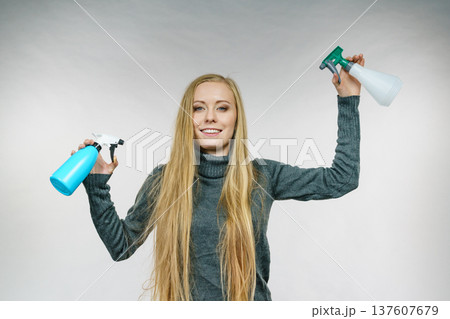 Female messy long hair holds spray bottle Female messy long hair holds spray bottle 137607679