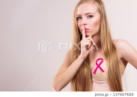 Woman pink cancer ribbon on breast 137607688
