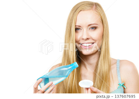 Woman using cleanser cosmetic Woman using cleanser cosmetic 137607695