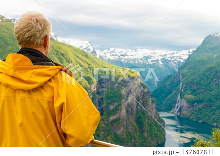 Tourist looking at Geirangerfjord from Flydasjuvet viewpoint Norway 137607811