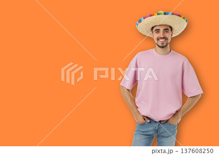 Cinco de Mayo, Man wearing a sombrero stands smiling and showing joy 137608250
