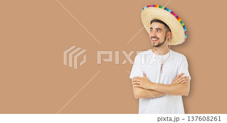 Cinco de Mayo, Young man in sombrero smiles and poses for celebration Cinco de Mayo, Young man in sombrero smiles and poses for celebration 137608261