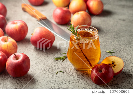 Apple juice and fresh apples on a kitchen table. Apple juice and fresh apples on a kitchen table. 137608602