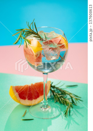 Cocktail with gin, tonic, grapefruit, and rosemary. 137608613