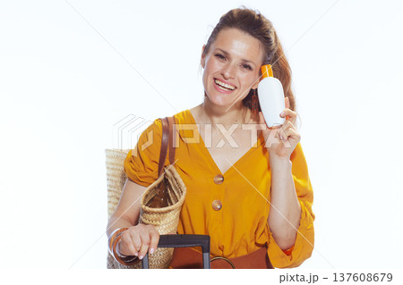 Cheerful Woman with Sunscreen Bottle and Summer Travel Gear Cheerful Woman with Sunscreen Bottle and Summer Travel Gear 137608679