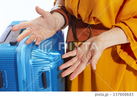 Traveler Reacting to Damaged Suitcase With Frustration Traveler Reacting to Damaged Suitcase With Frustration 137608683