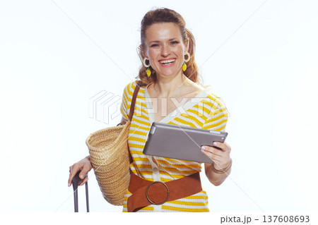 Smiling Traveler Checking Flight Status on Digital Tablet 137608693