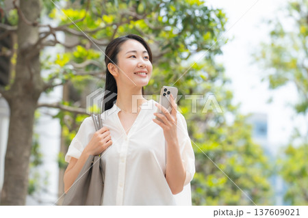 女性 カジュアル 初夏 歩く スマホ 女性 カジュアル 初夏 歩く スマホ 137609021