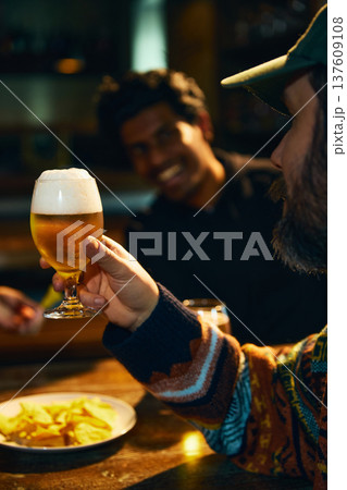 Beer glass toast in pub bar with friends enjoying social drinking and relaxed nightlife atmosphere Beer glass toast in pub bar with friends enjoying social drinking and relaxed nightlife atmosphere 137609108